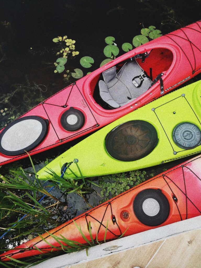 Top view of vibrant kayaks docked at a riverbank, showcasing nature and adventure in Kyiv.